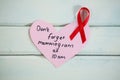 Overhead view of red AIDS awareness ribbon on heart shape reminder Royalty Free Stock Photo