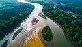 Aerial view of river confluence with muddy brown water merging into greenish water surrounded by lush green forest Royalty Free Stock Photo