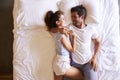 Overhead View Of Romantic Couple Lying In Bed Together Royalty Free Stock Photo