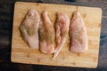 Seasoned Chicken Breast Cutlets on a Bamboo Cutting Board Royalty Free Stock Photo