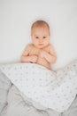 Overhead view of a serious baby boy lying in a crib Royalty Free Stock Photo