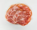 Top view of a serving of dry coppa on a white plate