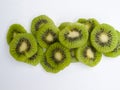 Overhead view of several slices of green kiwis