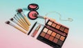 A vibrant collection of makeup brushes eyeshadow palette blush and lipstick arranged artfully on a gradient background Royalty Free Stock Photo