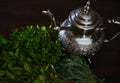 Overhead view Silver teapot and bunch of mint. Traditional Moroccan tea as symbol of the hospitality of Moroccan people