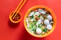 Overhead view of simple Chinese fishball noodle soup served in bowl