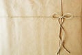 Overhead view of a single holiday package wrapped with eco friendly craft paper and tied with twine Royalty Free Stock Photo