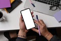 Stylish man hand using smart phone while sitting at creative workplace. Royalty Free Stock Photo