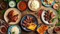 Overhead view of a table featuring grilled chicken, steak, rice, and assorted dips Royalty Free Stock Photo