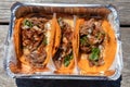 Three Beef Birria Tacos in a Takeout Container