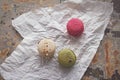 Overhead view of three yummy macaroons on crumpled paper