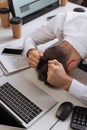 young businessman sitting near computers, smartphone Royalty Free Stock Photo