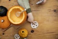 Overhead view of a toddlers hands playing with a pumpkin whilst making a lantern decoration for halloween