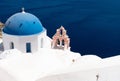 Whitewashed church and blue dome in the village of Fira on the idyllic island of Santorini Royalty Free Stock Photo