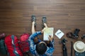 Overhead view of traveler man plan and backpack planning Royalty Free Stock Photo