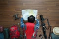 Overhead view of traveler man plan and backpack planning vacation travel Royalty Free Stock Photo