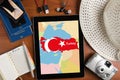 Overhead view of traveler`s accessories and map of Turkey on tablet, travel concept background, map of Turkey on tablet display an