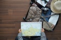 Overhead view of traveler woman plan vacation trip with map Royalty Free Stock Photo