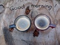 Overhead view of a two espresso cups of freshly brewed coffee on an improvised table Royalty Free Stock Photo