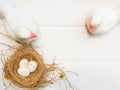 Overhead view of two white pigeon statue bird and bird nest with