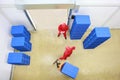 Overhead view of two workers in small warehouse Royalty Free Stock Photo