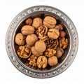 Overhead View of Walnuts and Hazelnuts in Ornate Silver Bowl on White Royalty Free Stock Photo