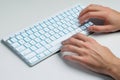 Hands typing on white keyboard Royalty Free Stock Photo