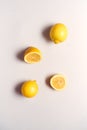 Overhead View Of Whole And Halved Fresh Lemons On White Background