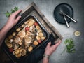 Roasted sea breams - dorado sea fish with tomato and potatoes on baking pan.