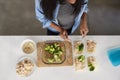 Overhead View Of Woman In Kitchen Preparing High Protein Meal