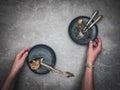 Woman`s hands tidying up skeleton sea breams - dorado sea fish on plate.e.