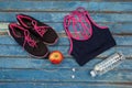 Overhead view of womenswear with apple and bottle by headphones