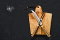 Overhead view of wooden cutting board with steak knife and fork Royalty Free Stock Photo