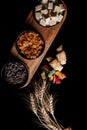 Overhead view of a wooden tray filled with several colorful bowls of food.