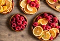 Overhead view of a wooden tray holding raspberries and orange slices. AI generated. Royalty Free Stock Photo