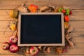 Overhead view of writing slate amidst fruits and vegetables with dry leaves Royalty Free Stock Photo