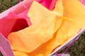 Overhead view of yellow and pink tissue paper in gift bag Royalty Free Stock Photo