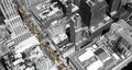 Overhead View Of Yellow Taxis Driving Through The Black And White Buildings Of Midtown Manhattan In New York City