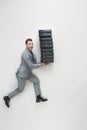 overhead view of young businessman carrying stack of folders