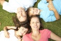 Overhead View Of Young Family Lying On Grass In Park Royalty Free Stock Photo