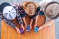 overhead view of young friends using smartphones with social