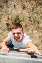 overhead view of young soldier climbing wooden barrier during obstacle run Royalty Free Stock Photo