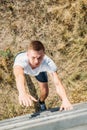 overhead view of young soldier climbing wooden barrier during obstacle run Royalty Free Stock Photo