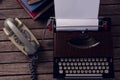 Vintage typewriter and telephone on wooden table Royalty Free Stock Photo