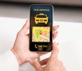 Overhead of woman holding smartphone with taxi app interface