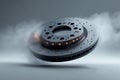 Overheated brake disc with smoke coming out on gray studio background Royalty Free Stock Photo