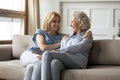 Overjoyed adult mom and daughter have fun at home