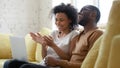 Overjoyed african American couple have fun using laptop together Royalty Free Stock Photo