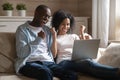 Overjoyed biracial couple excited with online win Royalty Free Stock Photo
