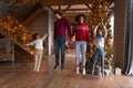 Overjoyed African American family jumping, enjoying winter holidays at home Royalty Free Stock Photo